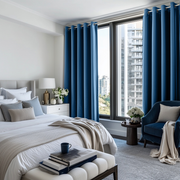 Steel Blue Velvet Grommet Blackout Curtains in a Bedroom with Crisp White Walls