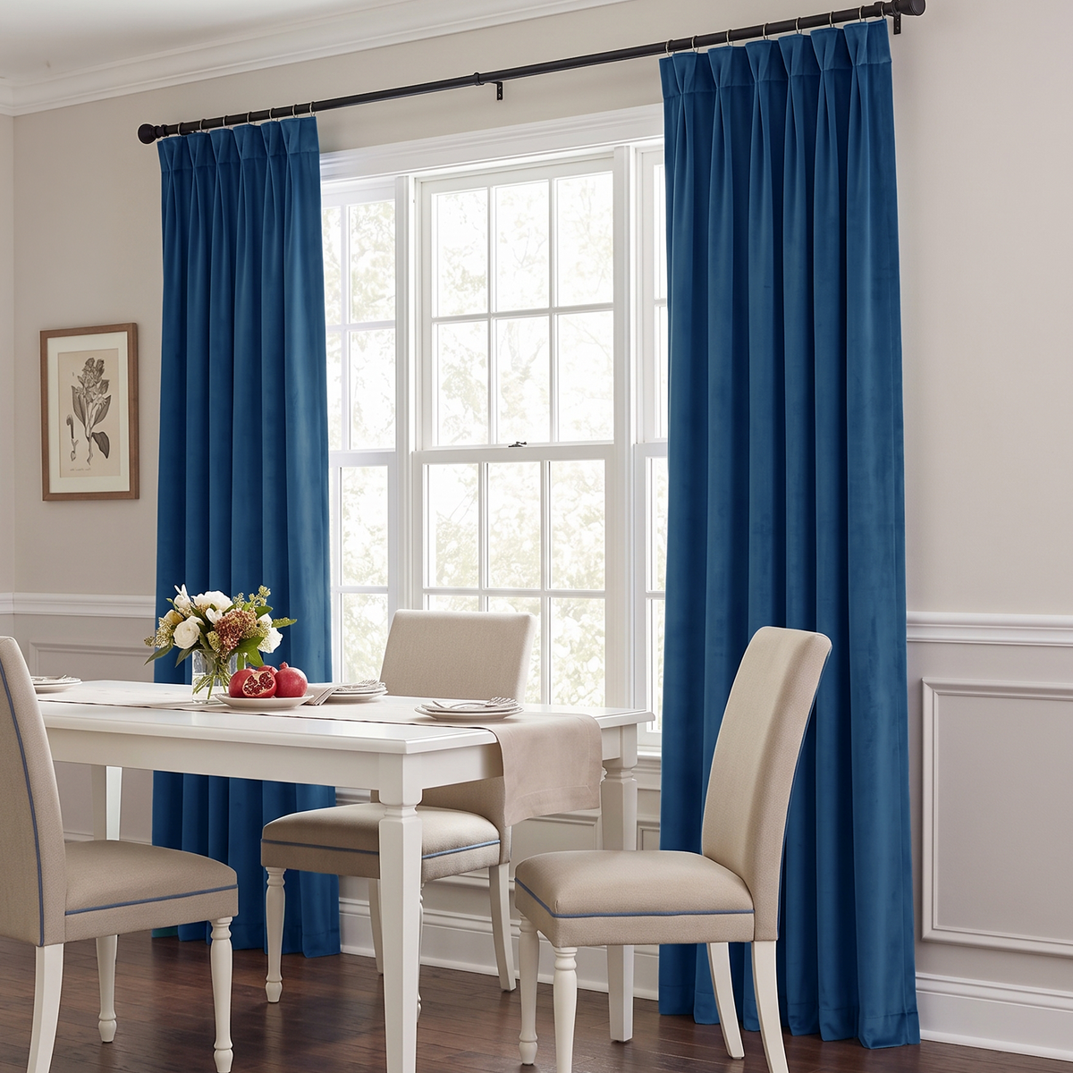 Elegant Steel Blue curtains frame a bright dining room window, beautifully complementing the white furniture and neutral interior