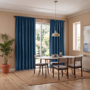 Steel Blue Velvet Curtains in a Dining Room with Neutral Walls and a Large White Table, Soft Gray Chairs