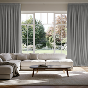 Stone Grey Linen Pencil Pleat Extra Long Curtains in a Contemporary Living Room with Large Windows and a Garden View