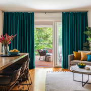 Teal Velvet S-Fold Blackout Curtains for Sliding Doors in a Living Room with Cream Walls
