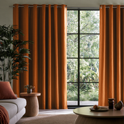 Terracotta Heavy Weight Linen Grommet Extra Long Curtains in a Modern Organic Living Room with Black-Framed Windows and Natural Textures