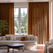 Terracotta Heavy Weight Linen Pencil Pleat Extra Long Curtains in a Contemporary Living Room with White Sofa and Large Garden Windows