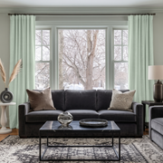 Mint Green Velvet Multitape Thermal Curtains in a Contemporary Living Room with Pale Gray Walls and a Charcoal Sofa