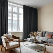 Steel Black Velvet Pencil Pleat Curtains in a Modern Living Room with a Light Grey Sofa