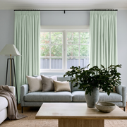 Mint Green Velvet Pencil Pleat Curtains in a Cozy Living Room with Soft Gray Walls and a Light Gray Sofa