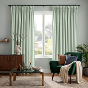 Mint Green Velvet Pinch Pleat Curtains in a Modern Living Room with Pale Blue Walls and an Emerald Accent Chair
