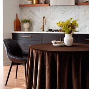 Chocolate Brown Velvet Round Tablecloth in a Modern Kitchen with White Marble Herringbone Tiles and Black Chair