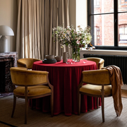 Dark Deep Red Velvet Round Tablecloth in an Elegant Dining Room with Beige Curtains and Mustard Velvet Chairs
