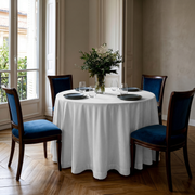 Off-White Velvet Round Tablecloth in an Elegant Dining Room with Soft Beige Walls and Blue Velvet Chairs