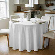 White Linen 120 Inch Round Tablecloth in a Bright Kitchen Dining Space with White Cabinetry and Cream Upholstery