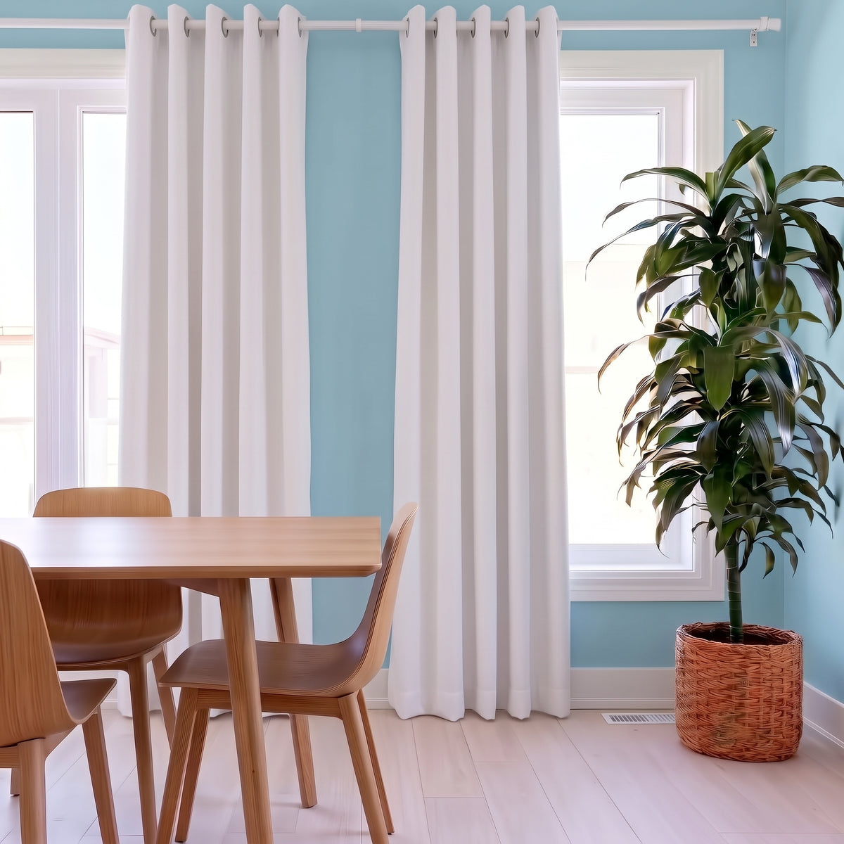 White Linen Grommets Dining Room Curtain in a Casual Dining Room with Light Blue Walls, a Light Wood Dining Set and a Large Potted Plant - Blackout Lining