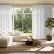 White Linen Pencil Pleat Extra Long Curtains in a Bright Contemporary Living Room with Floor-to-Ceiling Windows and Neutral Furniture