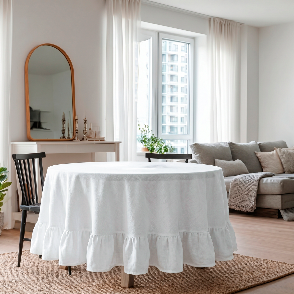 White Linen Round Ruffle Tablecloth in a Bright Living Dining Space with Soft White Walls and Beige Upholstery