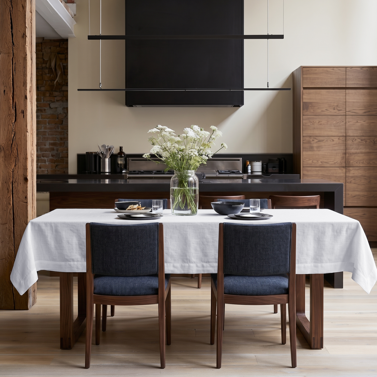 White Rectangular Linen Tablecloth in a Modern Kitchen with Walnut Cabinetry
